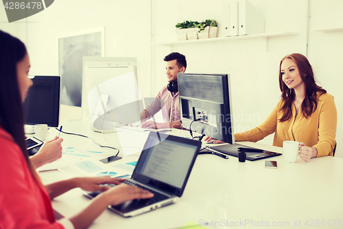Image of creative team with computers working at office