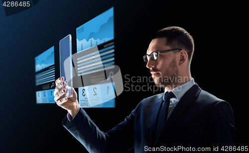 Image of businessman with tablet pc and exchange charts