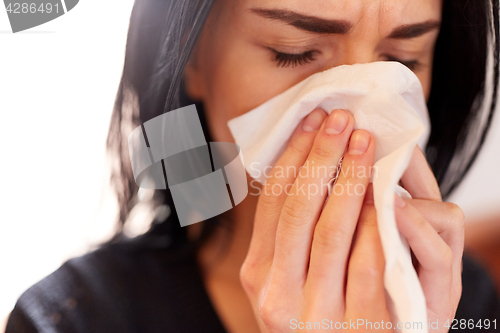 Image of close up of woman with wipe crying at funeral