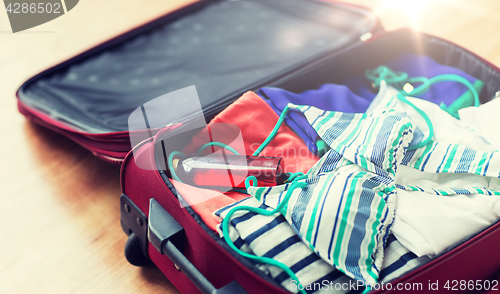 Image of close up of travel bag with beach clothes