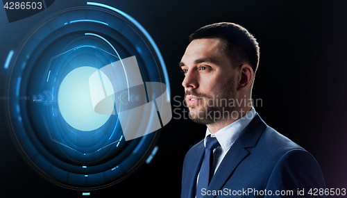 Image of businessman with virtual projection over black
