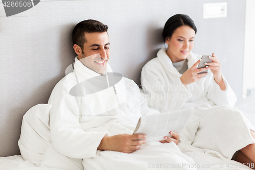 Image of happy couple in bed at home or hotel room