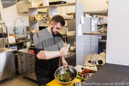 Image of chef cook making food at restaurant kitchen