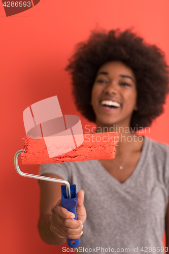 Image of black woman painting wall