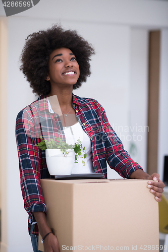 Image of Black girl moving in the new apartment