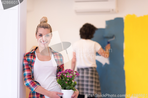 Image of happy young couple doing home renovations