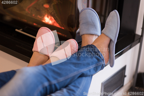 Image of Young couple  in front of fireplace