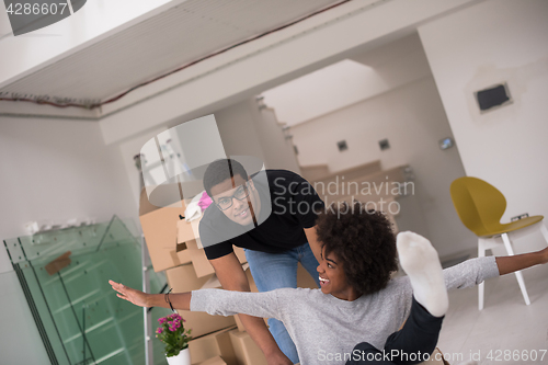 Image of African American couple  playing with packing material