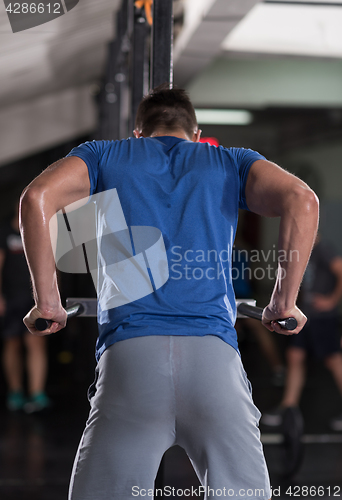 Image of man doing exercises parallel bars