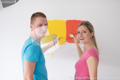 Image of couple painting interior wall