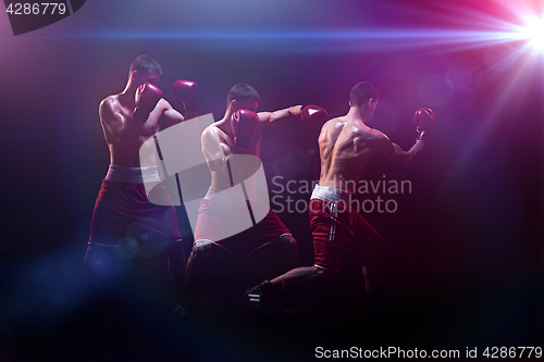 Image of The boxer boxing in a dark studio