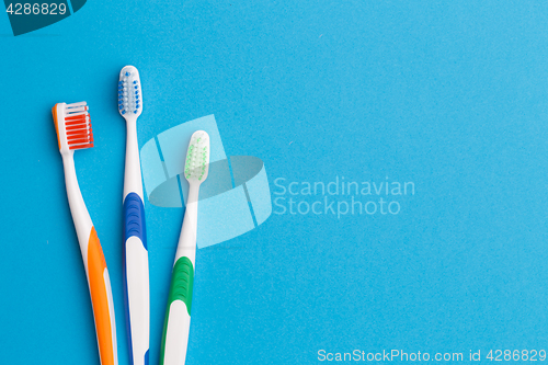 Image of Three toothbrushes , space for text