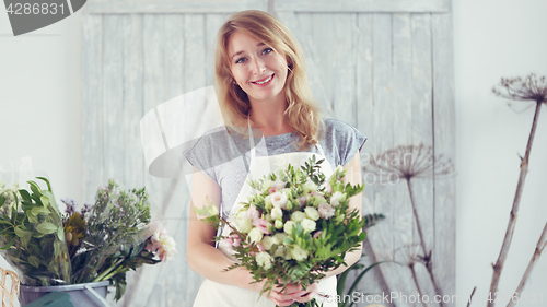 Image of Florists woman working with flowers