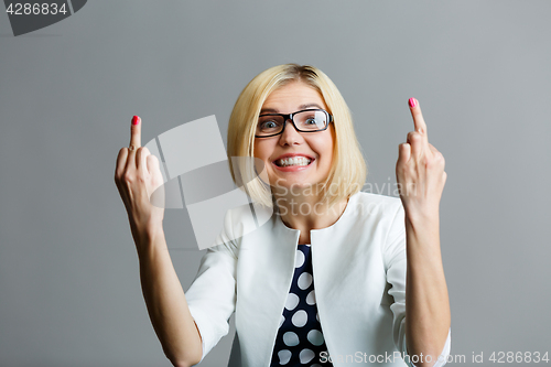 Image of Smiling blonde shows middle finger