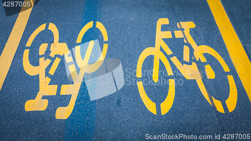 Image of Bicycle signs painted on asphalt