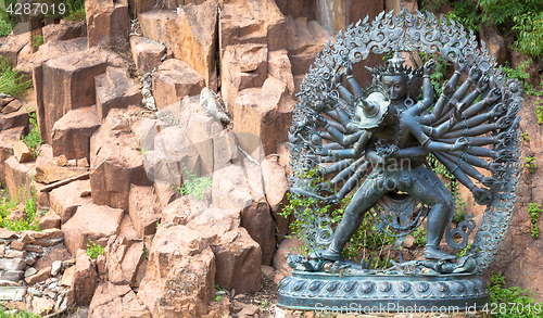 Image of Tantric Deities statue in Ritual Embrace located in a mountain g