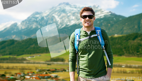 Image of happy man with backpack traveling in highlands