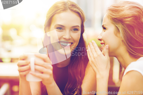 Image of young women drinking coffee and talking at cafe