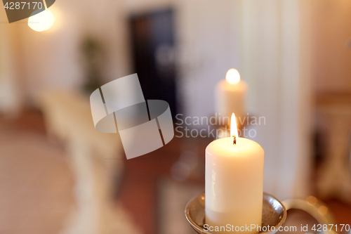 Image of candles burning in church