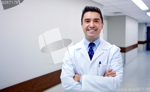 Image of smiling doctor at hospital corridor