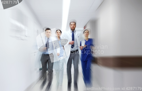 Image of group of medics walking along hospital