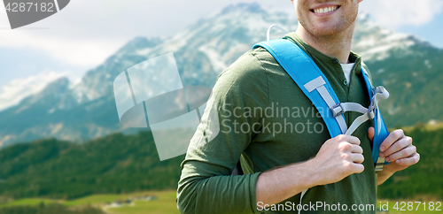 Image of close up of happy man with backpack traveling