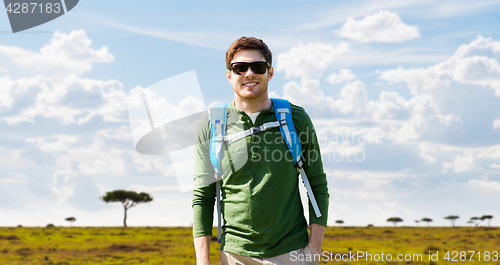 Image of happy young man with backpack traveling in africa