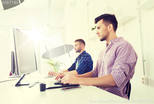 Image of man or designer with computer and tablet at office