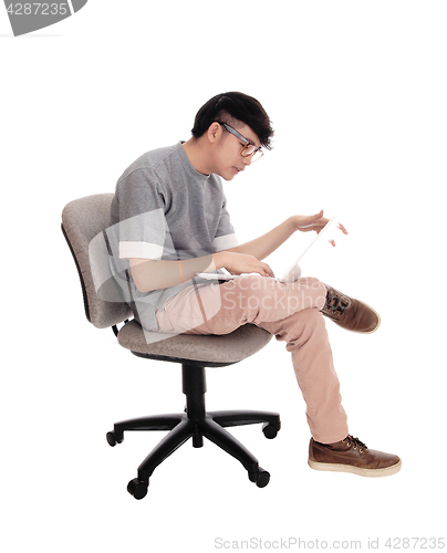 Image of Asian man working at his laptop.