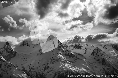 Image of Black and white view on snow mountains in evening