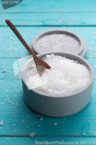 Image of sea salt on wooden background