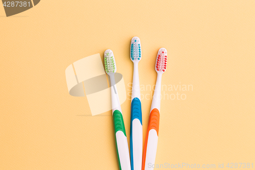 Image of Toothbrushes on empty orange background