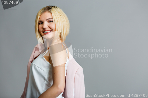Image of Smiling blonde on empty background