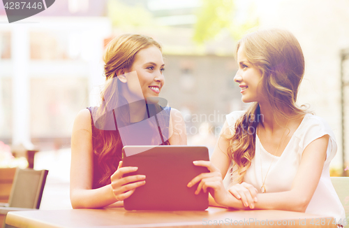 Image of happy young women or teenage girls with tablet pc