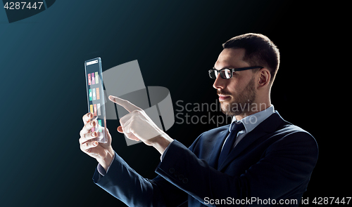 Image of businessman working with transparent tablet pc