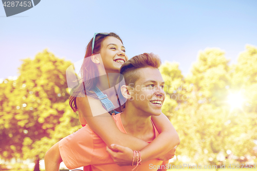 Image of happy teenage couple having fun at summer park