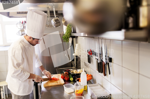 Image of happy male chef cooking food at restaurant kitchen