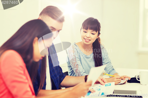 Image of happy creative team or students working at office