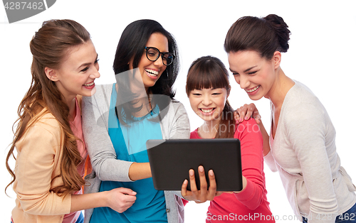 Image of international group of happy women with tablet pc