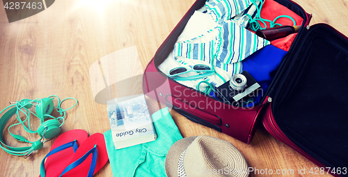 Image of close up of travel bag with clothes and stuff