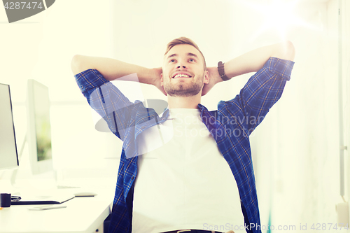 Image of happy creative man with computer at office