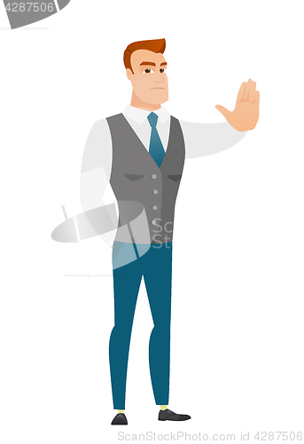 Image of Caucasian businessman showing stop hand gesture.