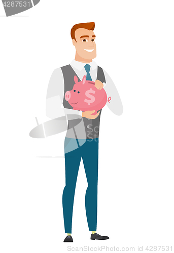 Image of Caucasian business man holding a piggy bank.