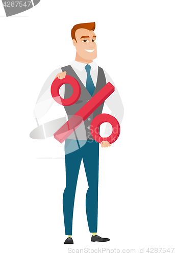 Image of Smiling businessman holding percent sign.