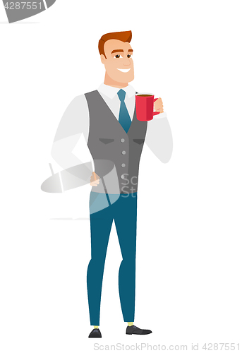 Image of Young caucasian businessman holding cup of coffee.