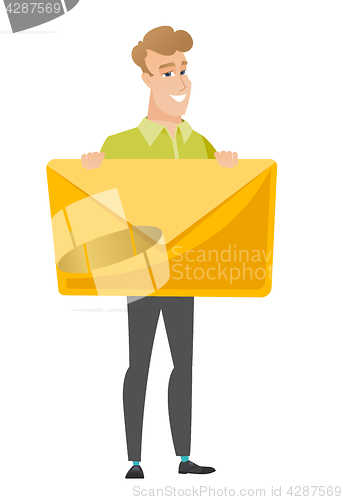 Image of Smiling businessman holding a big envelope.