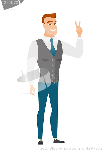 Image of Caucasian businessman showing the victory gesture.