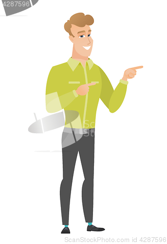 Image of Young caucasian businessman pointing to the side.