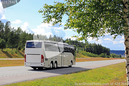 Image of White Bus Travels in Summer