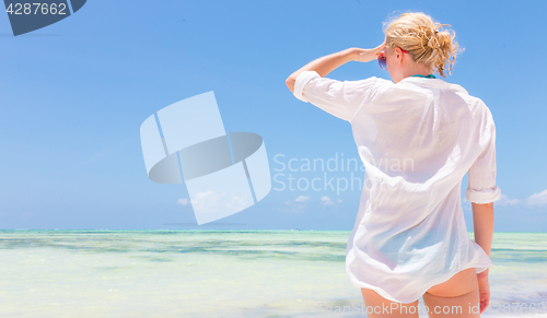 Image of Happy woman enjoying, relaxing joyfully in summer on tropical beach.